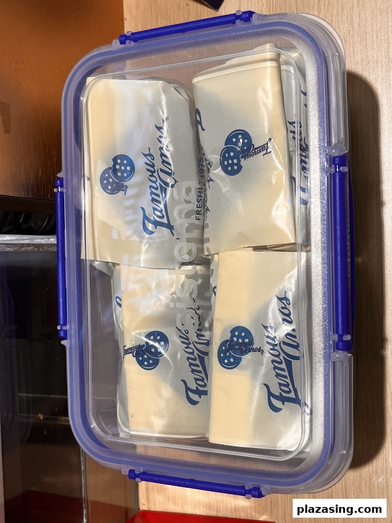 Famous Amos cookies in individual packets stored in a clear plastic container.