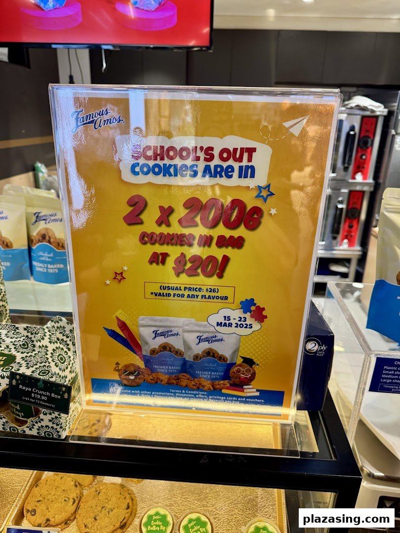 A Famous Amos in-store display showcasing a 'School's Out' cookie promotion and other cookie products.