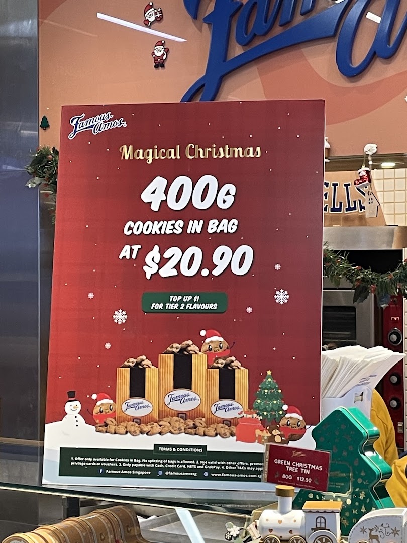 A festive Famous Amos promotional display featuring a Christmas cookie offer.