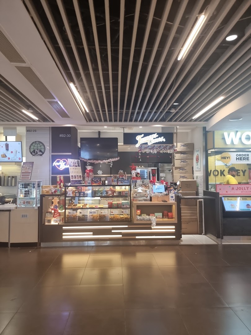 The Famous Amos shop front with its display counter and signage in a brightly lit mall setting.