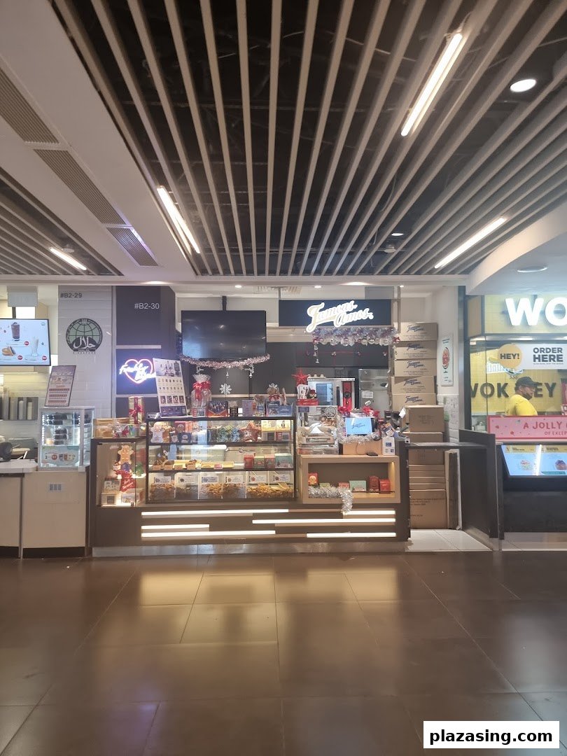 The Famous Amos shop front with its display counter and signage in a brightly lit mall setting.