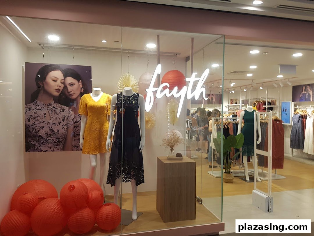 The bright storefront of Fayth fashion boutique showcasing dresses on mannequins and a view into the stylish interior.