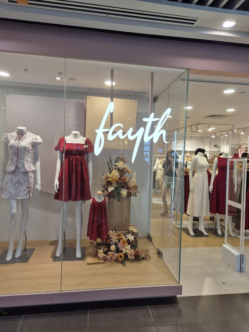 The Fayth shopfront features mannequins displaying elegant dresses and the brand's illuminated logo.