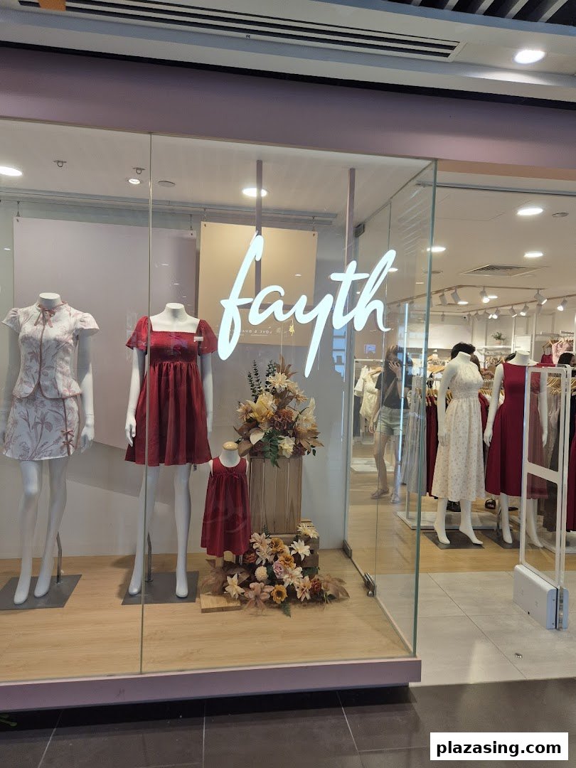 The Fayth shopfront features mannequins displaying elegant dresses and the brand's illuminated logo.