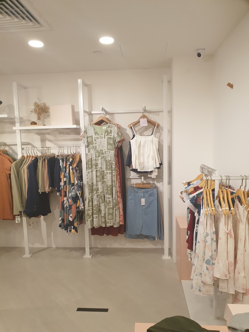 Interior view of Fayth Plaza Singapura, showcasing women's apparel on display racks.