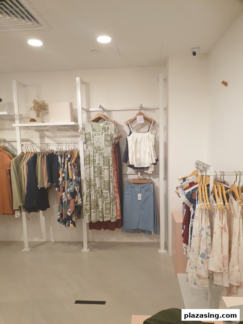 Interior view of Fayth Plaza Singapura, showcasing women's apparel on display racks.