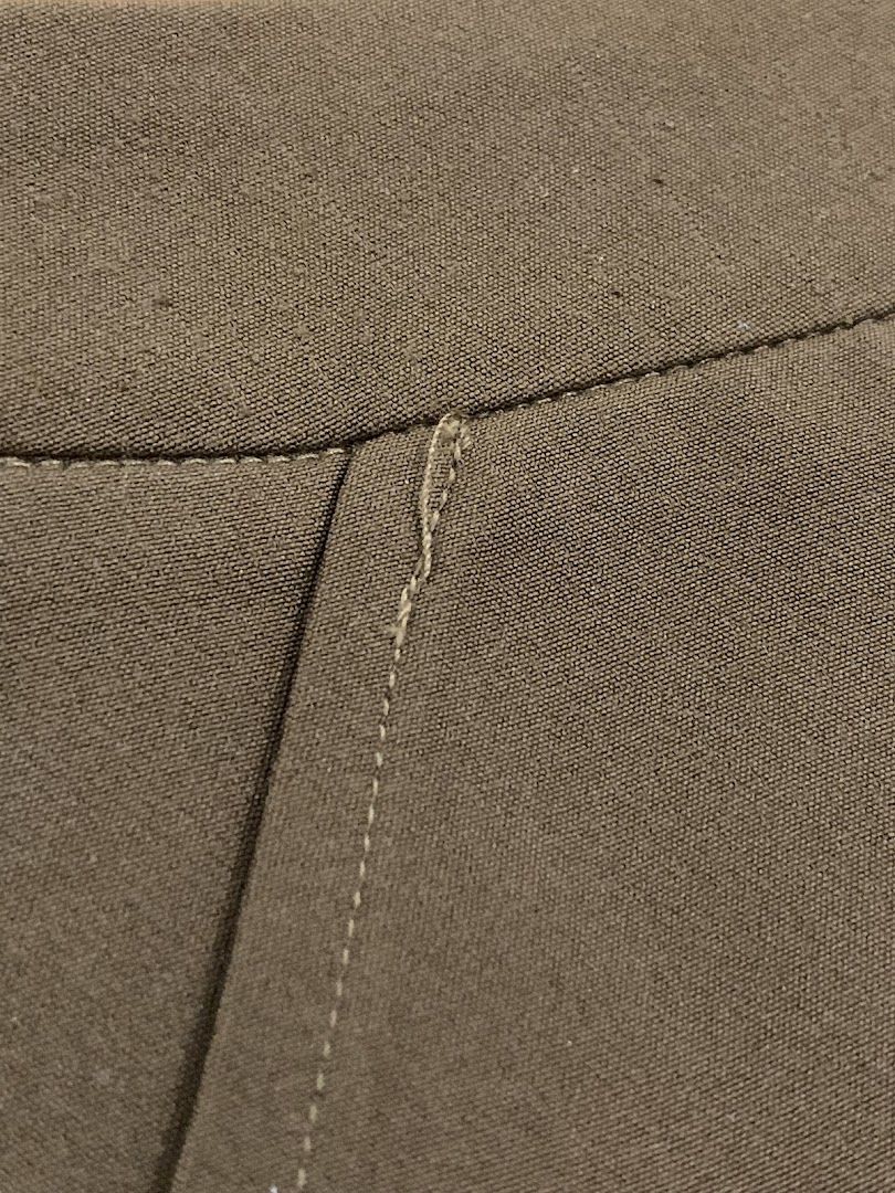 Close-up of finely woven fabric with detailed stitching, showcasing product quality.