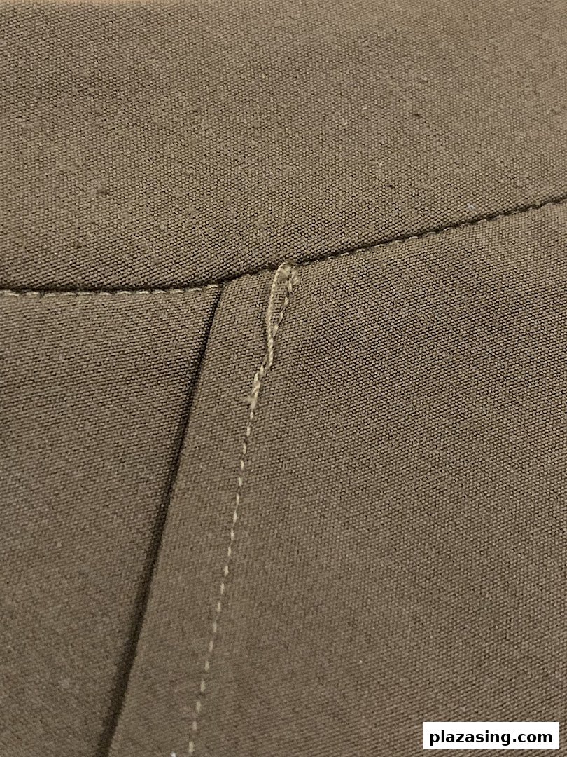 Close-up of finely woven fabric with detailed stitching, showcasing product quality.