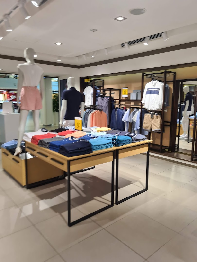 An interior view of the G2000 store, showcasing neatly folded and hung apparel on display tables and racks.