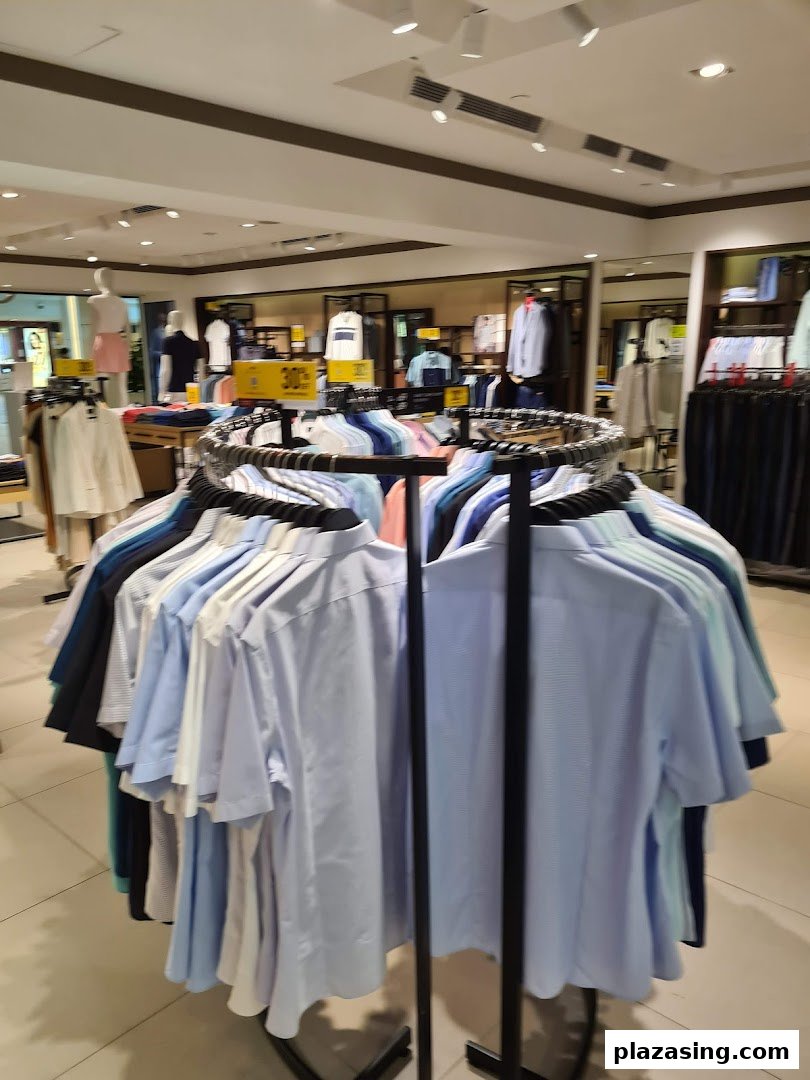 An interior view of G2000 showcasing a circular display rack filled with men's shirts and other apparel.