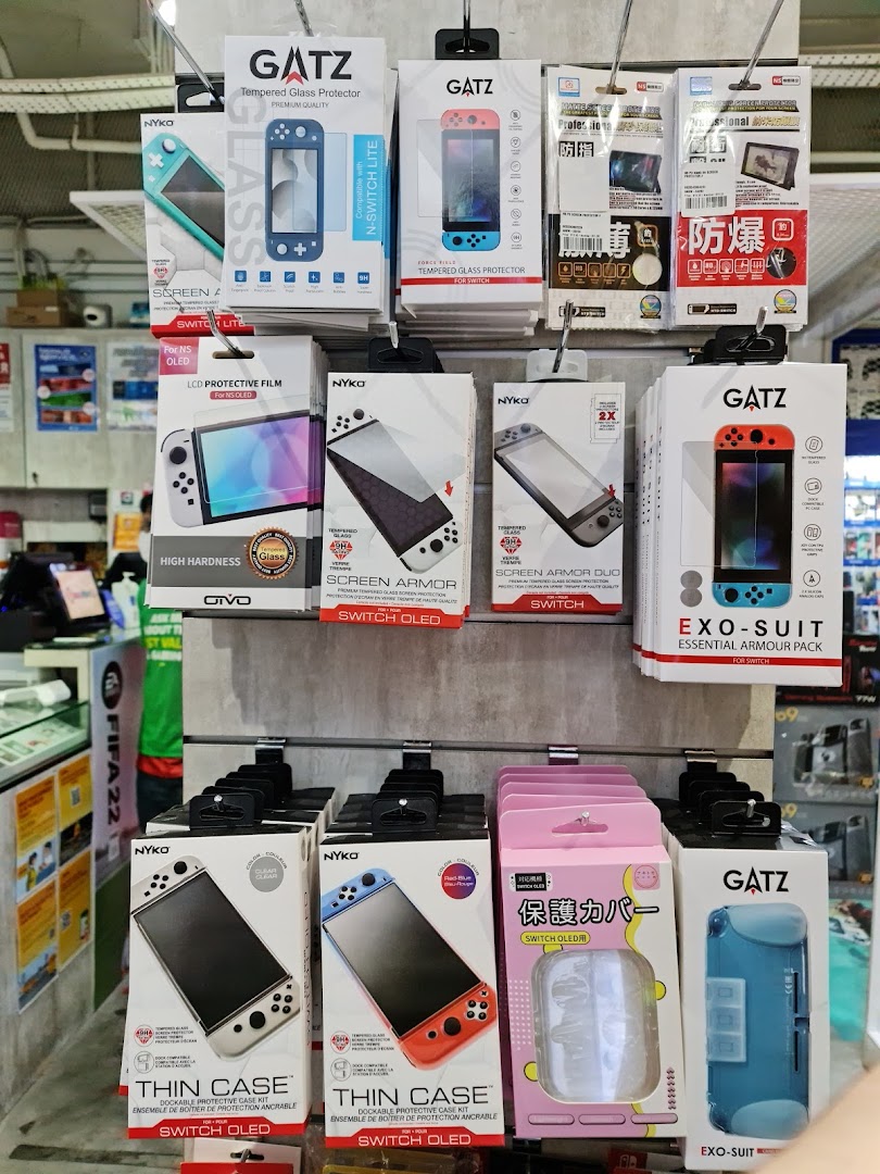 A display of Nintendo Switch and Switch OLED/Lite accessories, including screen protectors and cases, from brands like GATZ and NYKO.