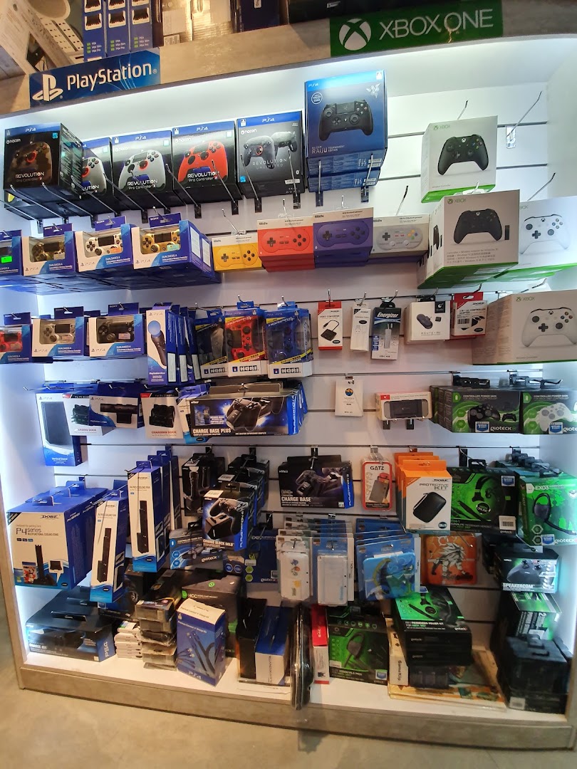 Shelves packed with gaming controllers and accessories for PlayStation and Xbox.