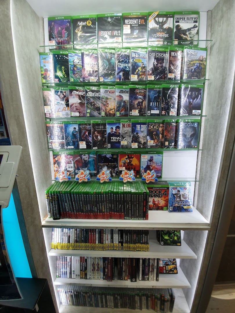 A tall display shelf at GameMartz showcasing a wide selection of Xbox One video games.