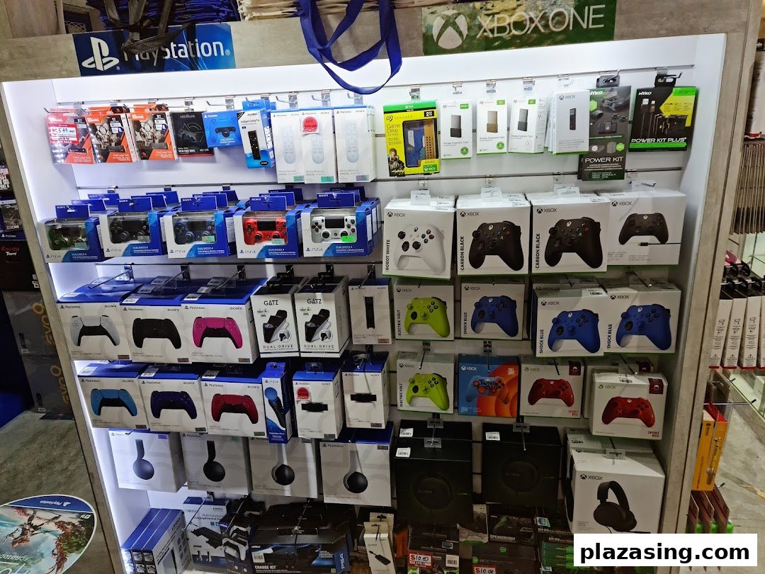 A vibrant display of PlayStation and Xbox gaming controllers, headsets, and accessories on shelves.