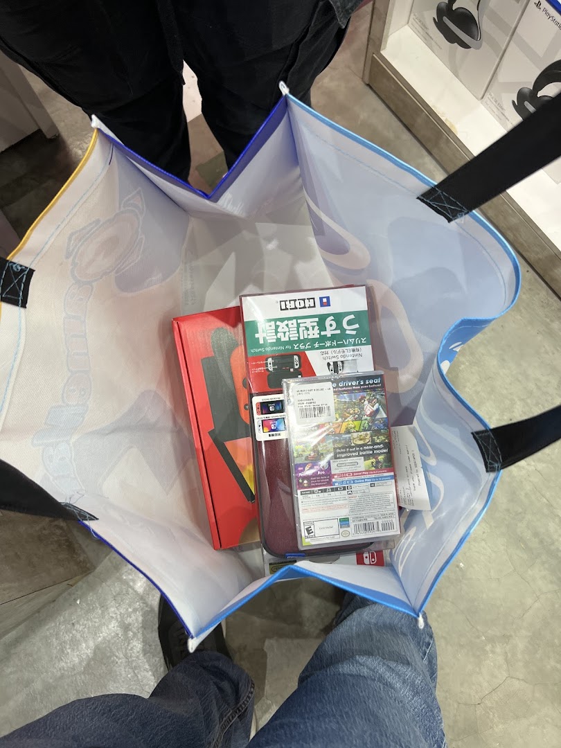 A shopping bag filled with newly purchased Nintendo Switch games and accessories.