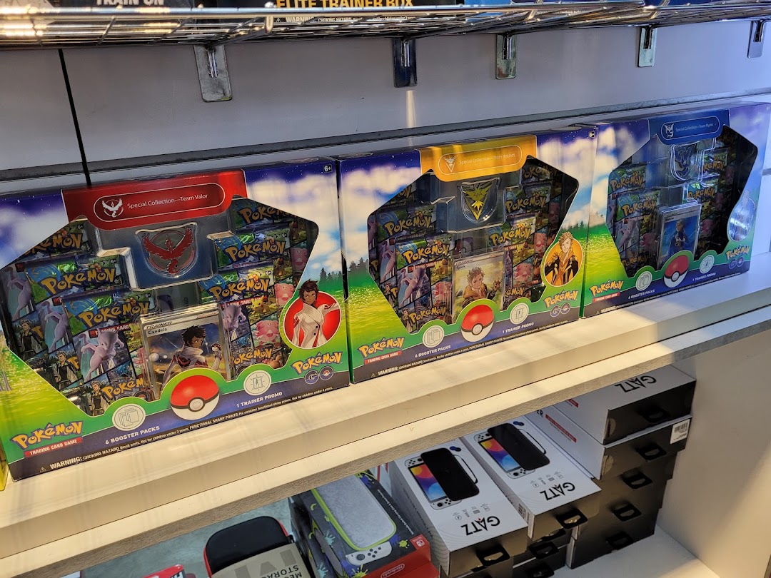 Pokemon TCG special collection boxes and gaming accessories displayed on shelves.
