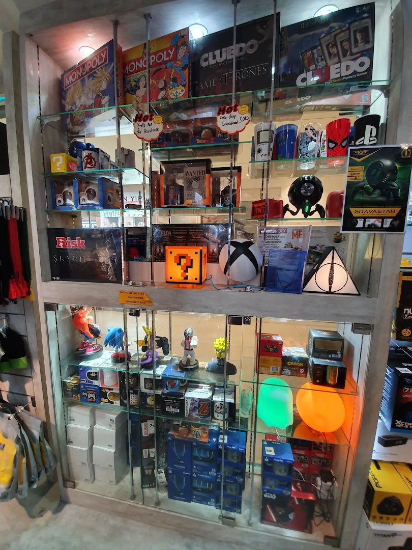 A glass display cabinet showcasing board games, video game merchandise, and pop culture collectibles.