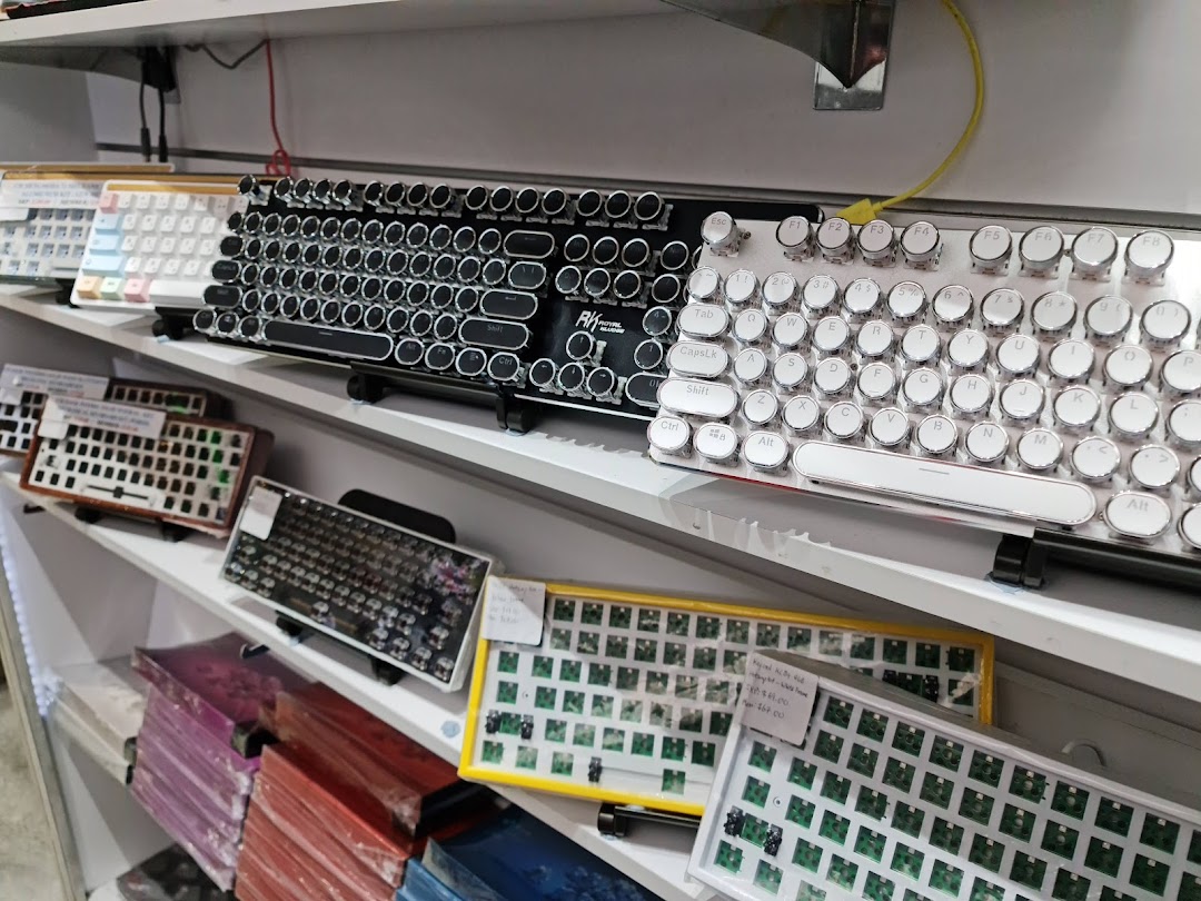 A vibrant display of various mechanical keyboards and components on shelves at GameMartz.