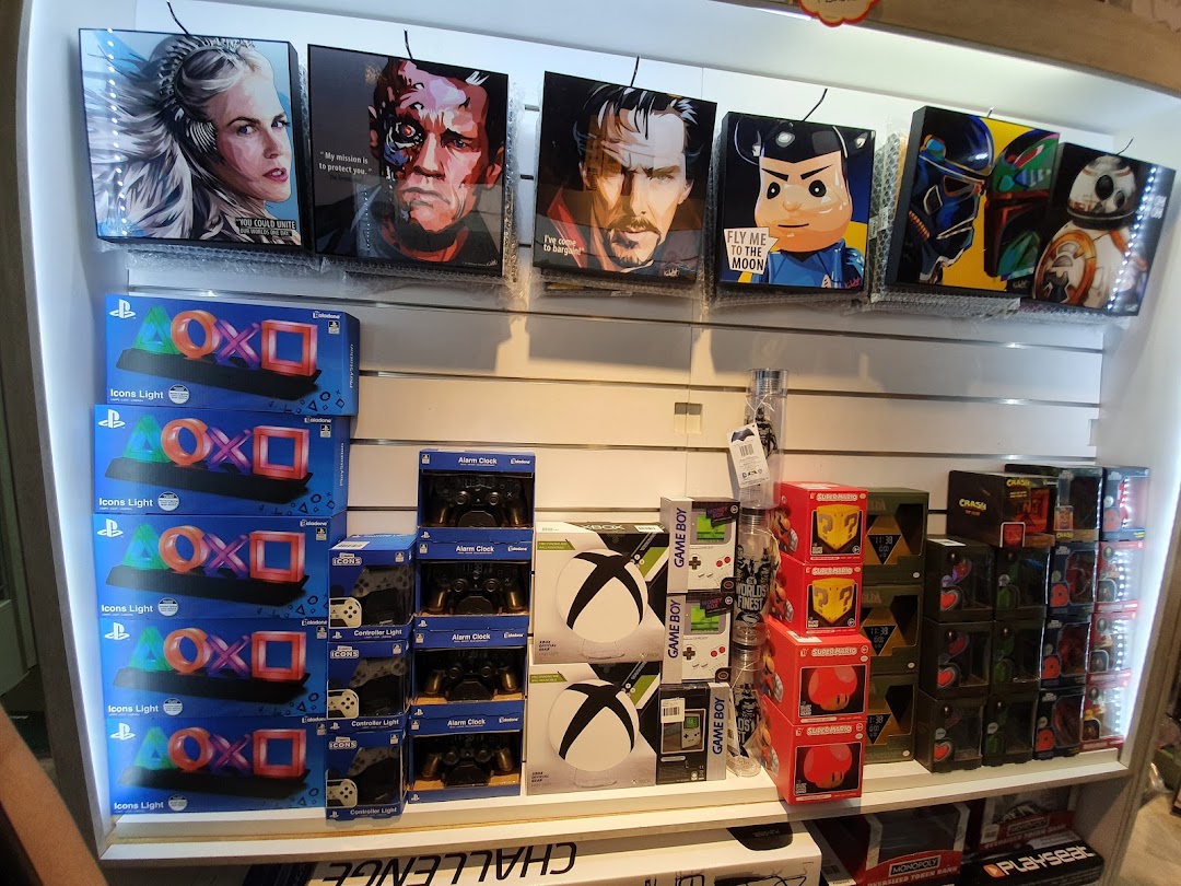 A display of gaming merchandise, pop culture collectibles, and novelty items like PlayStation Icons Lights and character art.