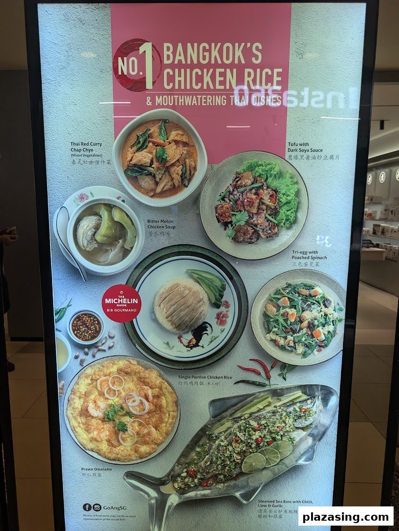 A vibrant display board showcasing various Thai dishes, including chicken rice and seafood, from Go-Ang Pratunam Chicken Rice.