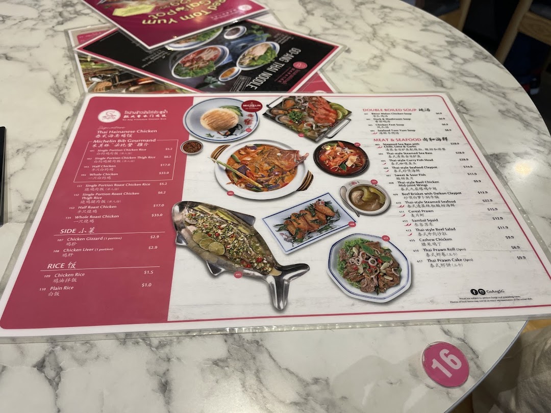 A detailed close-up of Go-Ang Pratunam Chicken Rice's menu, showcasing various Thai dishes.