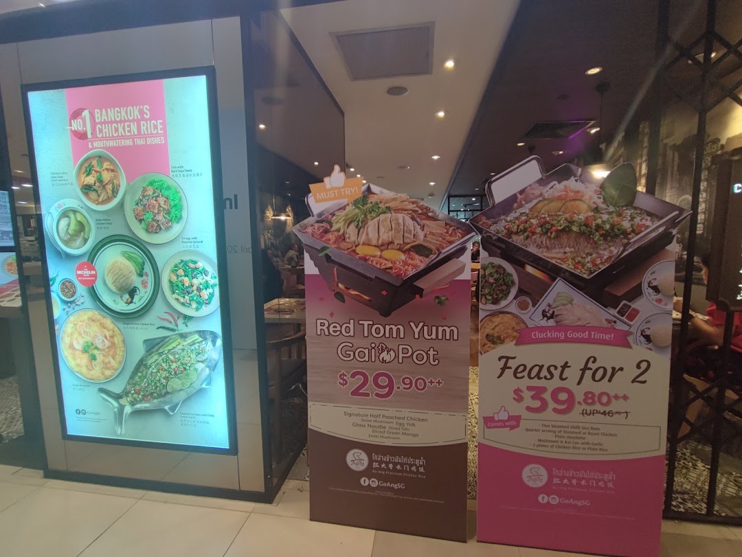 Promotional displays for Go-Ang Pratunam Chicken Rice, featuring Thai dishes and special meal deals.