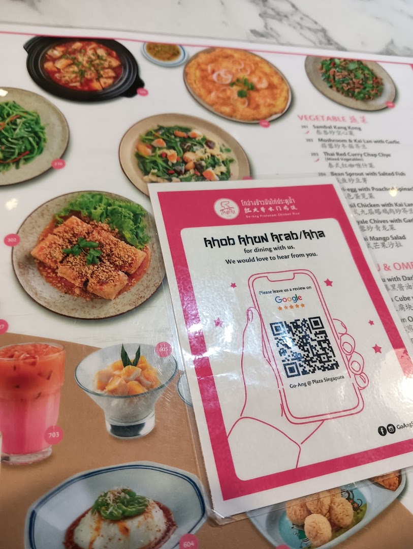 A vibrant menu display from Go-Ang Pratunam Chicken Rice, featuring various Thai dishes and a review QR code.