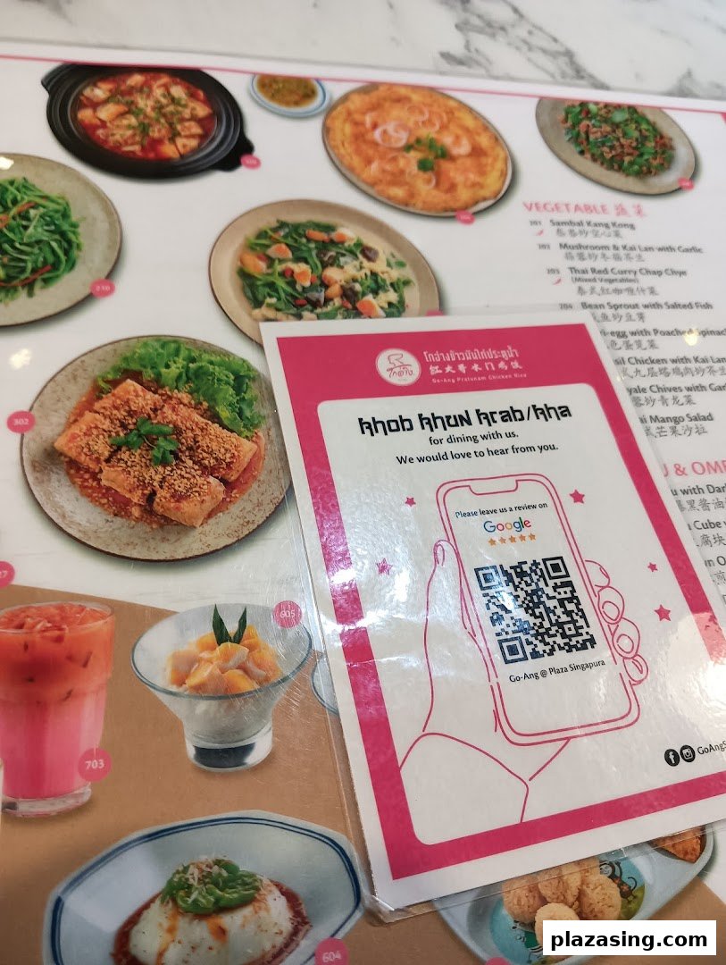 A vibrant menu display from Go-Ang Pratunam Chicken Rice, featuring various Thai dishes and a review QR code.