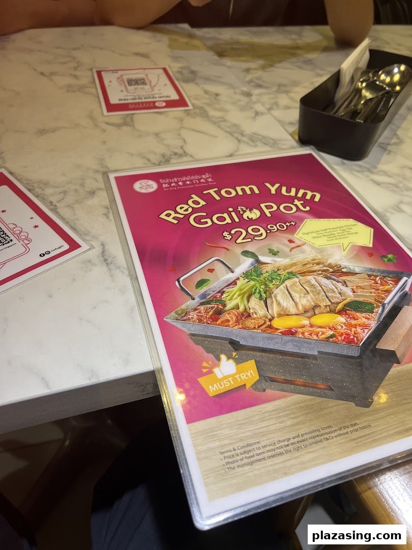 A vibrant menu display featuring the 'Red Tom Yum Gai Pot' with its price and ingredients.