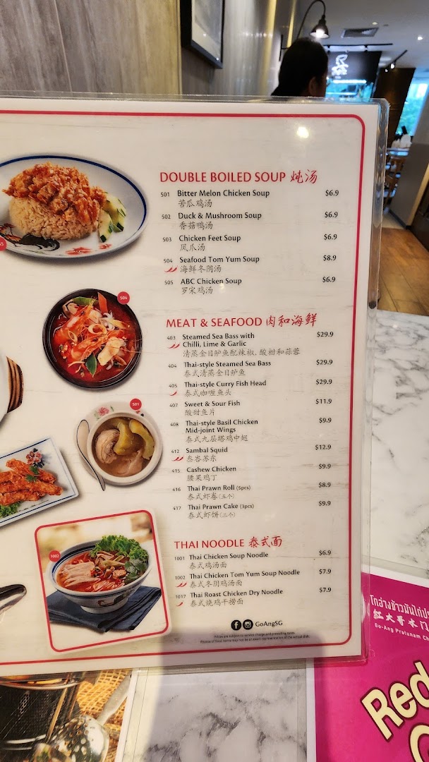 A close-up view of the menu from Go-Ang Pratunam Chicken Rice, featuring soups, meat, seafood, and noodle dishes.