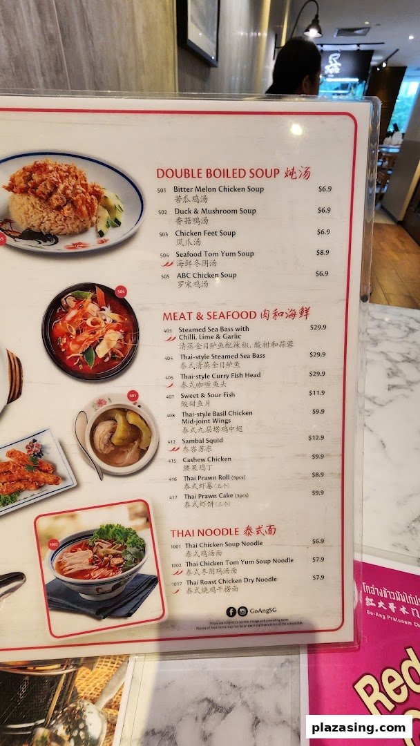 A close-up view of the menu from Go-Ang Pratunam Chicken Rice, featuring soups, meat, seafood, and noodle dishes.