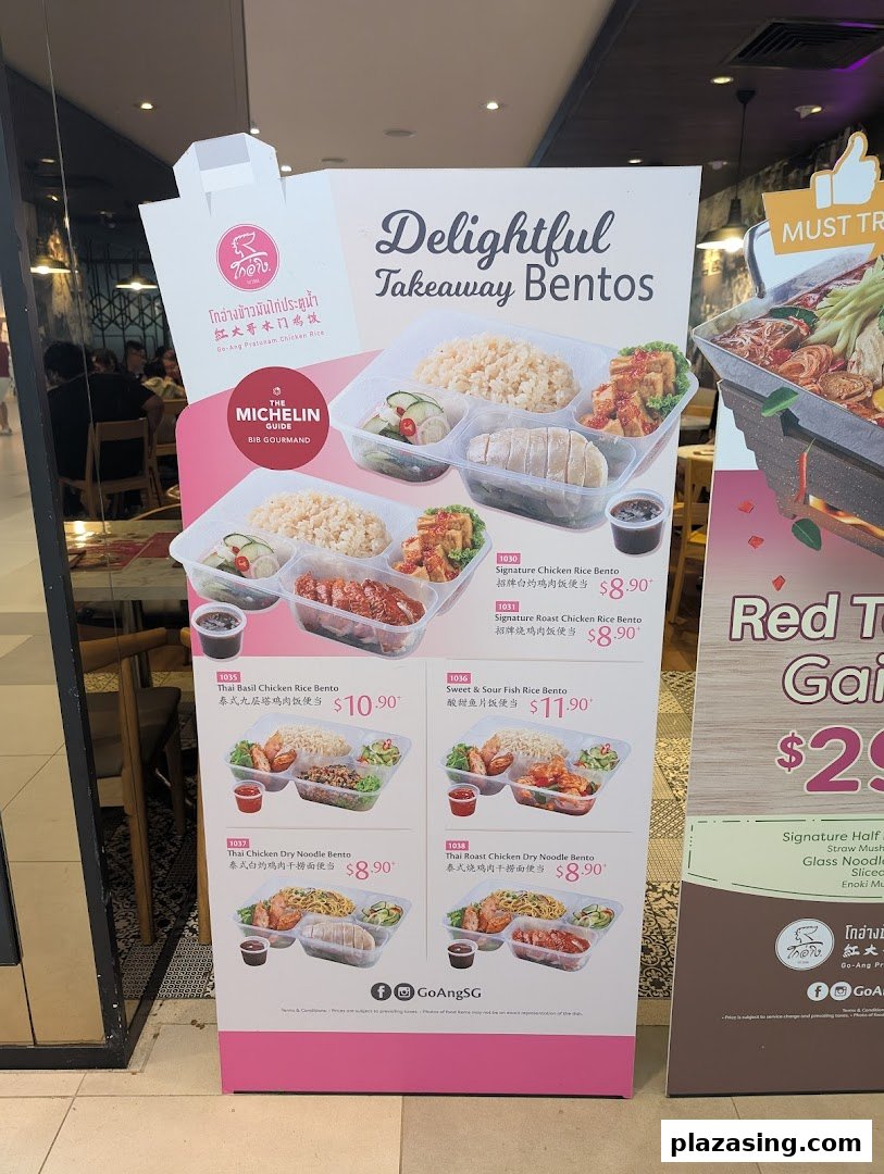 A promotional standee for Go-Ang Pratunam Chicken Rice, showcasing their takeaway bento sets.