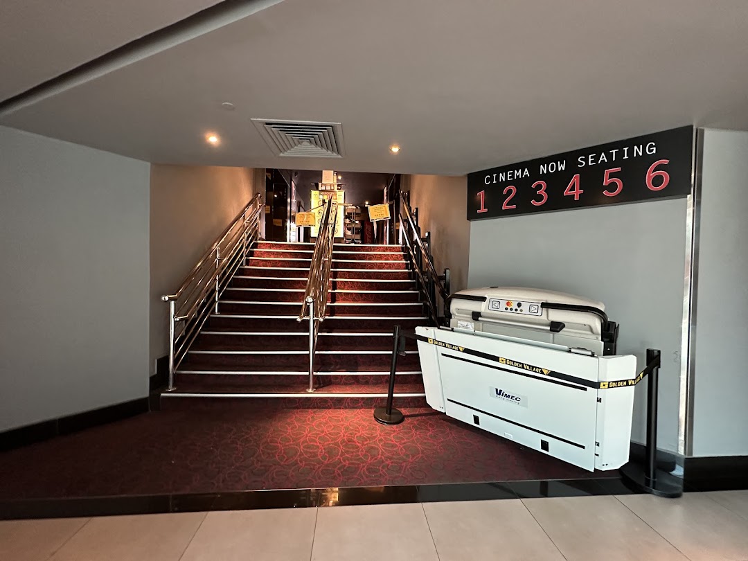 Entrance to cinema halls with stairs and accessibility lift, showing seating information for Golden Village Plaza.