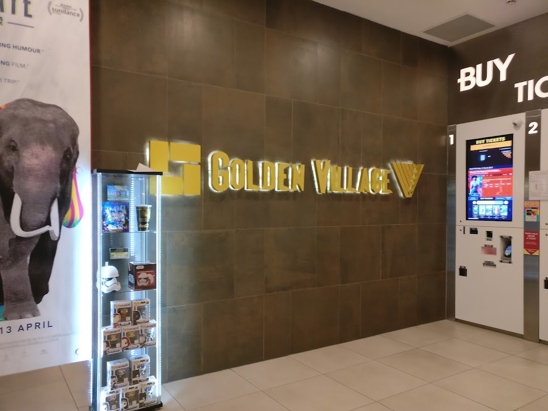 Golden Village cinema entrance featuring its logo, ticket kiosks, and a movie poster.