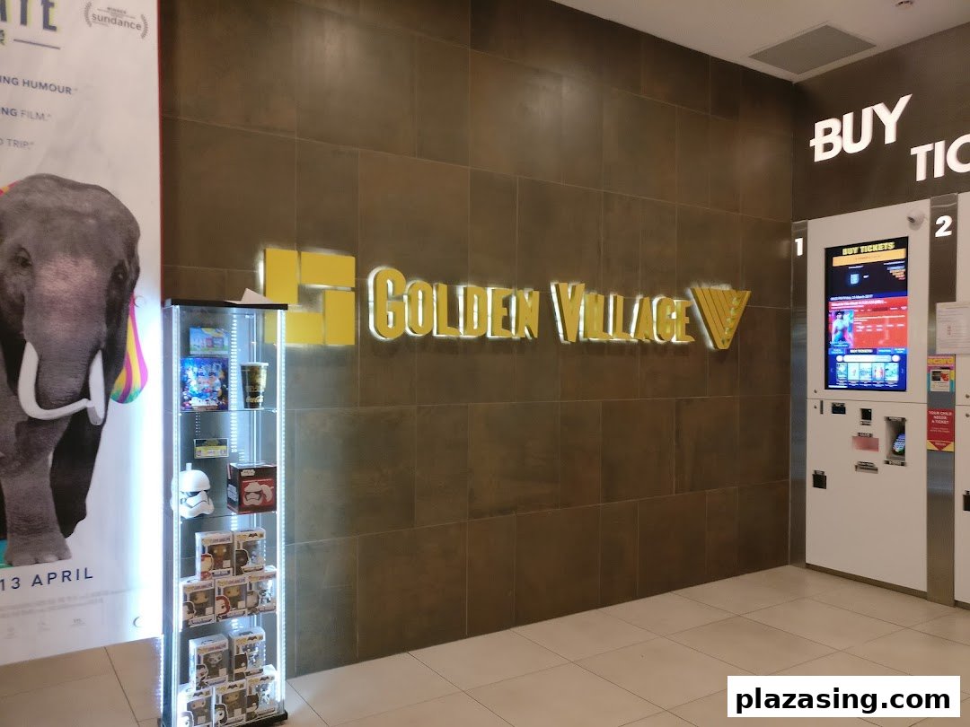 Golden Village cinema entrance featuring its logo, ticket kiosks, and a movie poster.