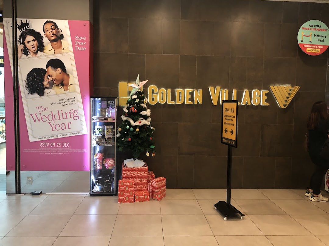 The entrance of Golden Village cinema featuring a movie poster, Christmas tree, and directional signage.