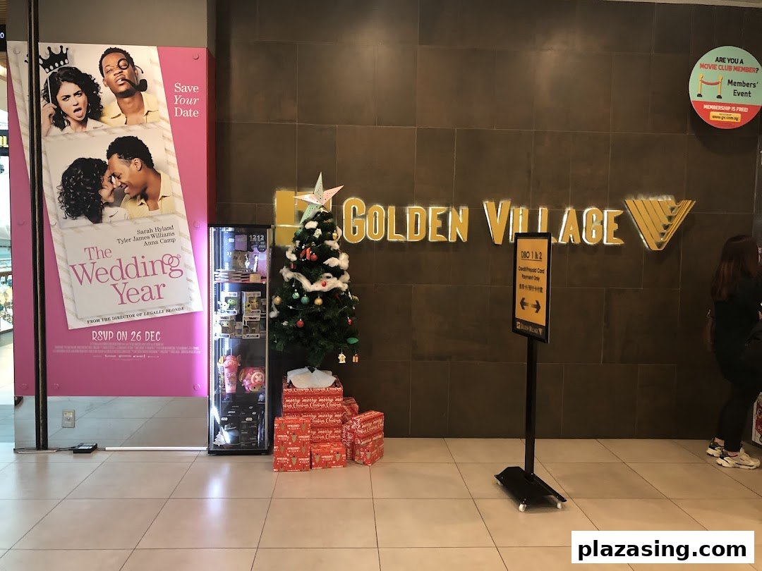 The entrance of Golden Village cinema featuring a movie poster, Christmas tree, and directional signage.