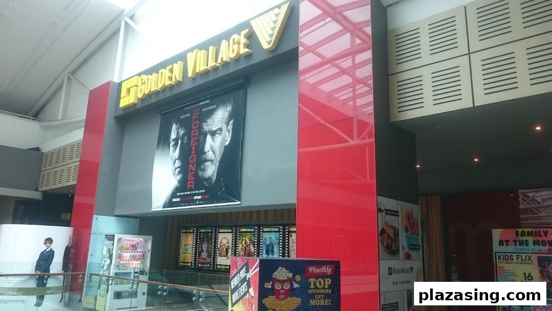 The Golden Village cinema entrance featuring movie posters, including 'The Foreigner', within a shopping mall.