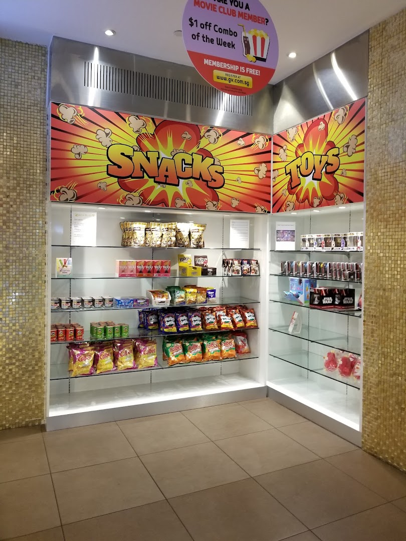 An interior view of a shop display featuring snacks, candies, and toys, with a movie club promotion.