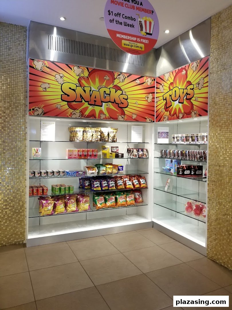 An interior view of a shop display featuring snacks, candies, and toys, with a movie club promotion.
