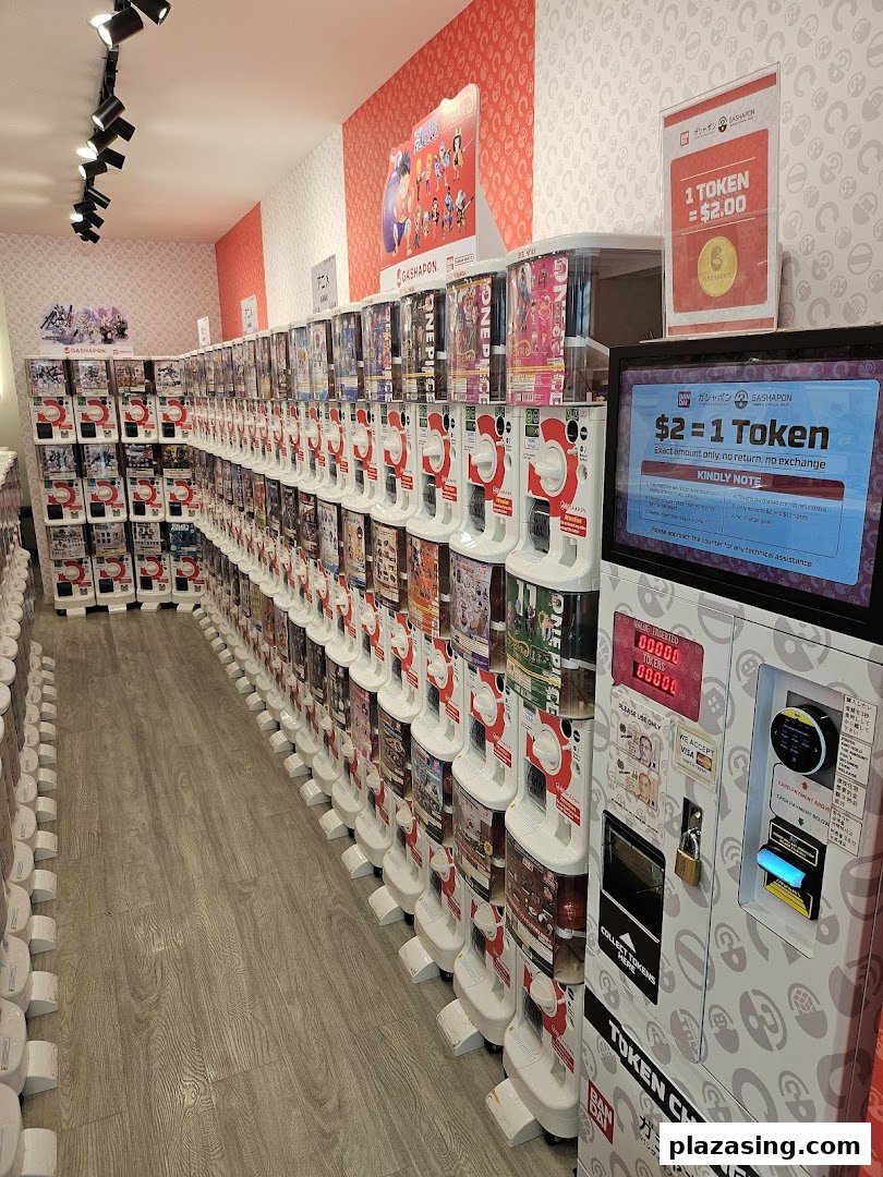 An interior view of a gashapon shop featuring rows of capsule toy vending machines.
