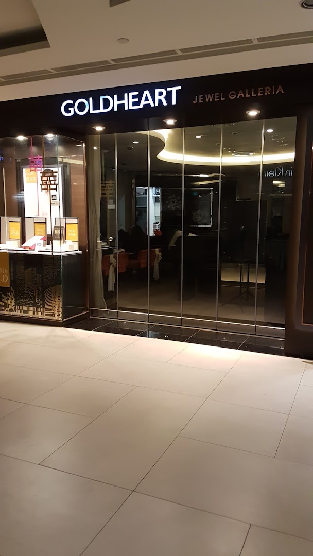 The illuminated storefront of Goldheart Jewel Galleria, showcasing its elegant entrance and display.