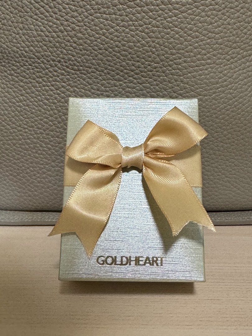 A light blue Goldheart gift box with a golden ribbon, ready for a special occasion.