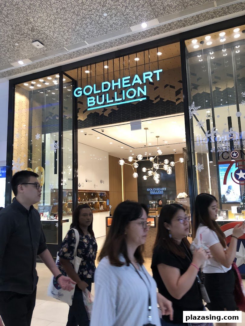 The Goldheart Bullion shop front with its illuminated sign, showcasing a modern interior and passersby.