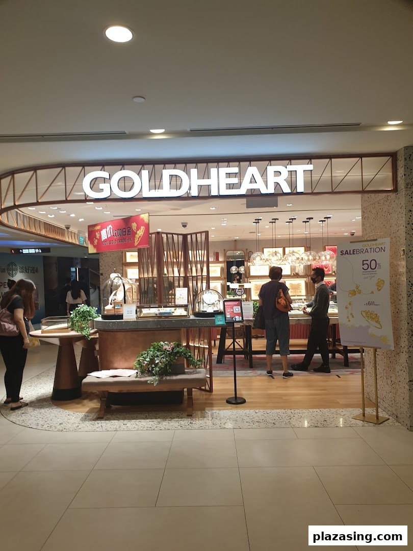 The Goldheart Jewelry shop front with customers browsing displays and promotional signage.