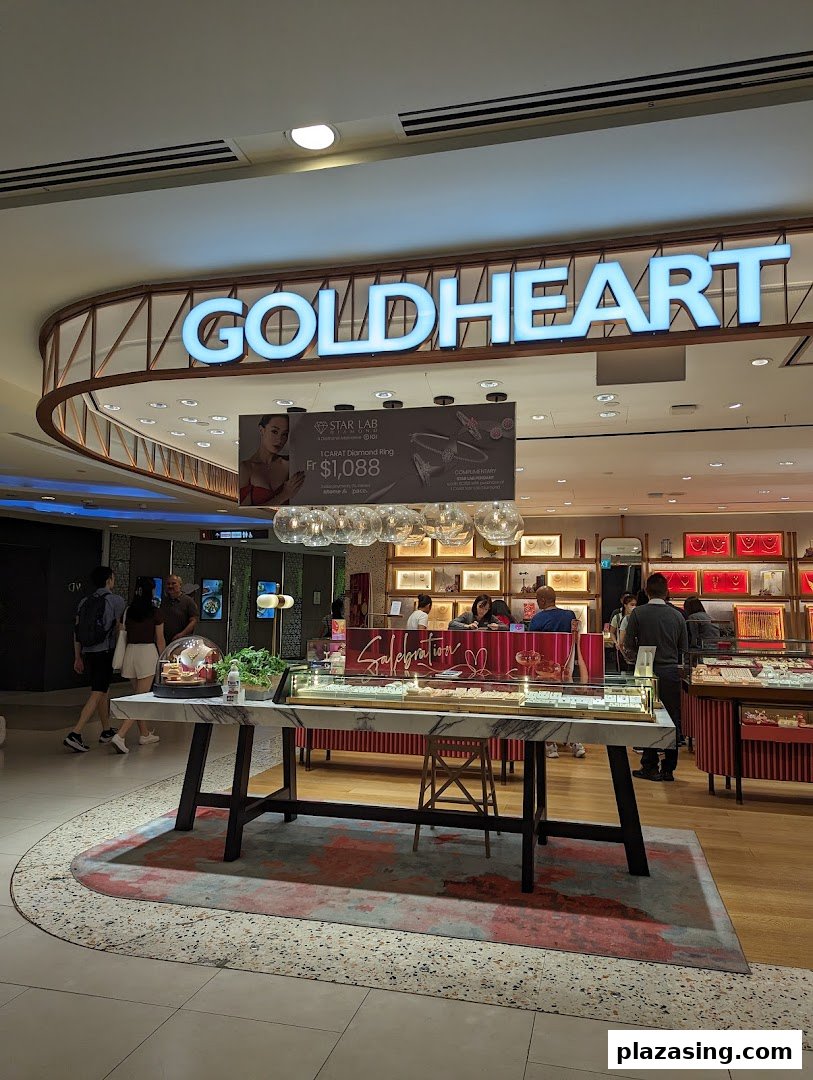 The illuminated Goldheart Jewelry shop front with display cases and customers inside.