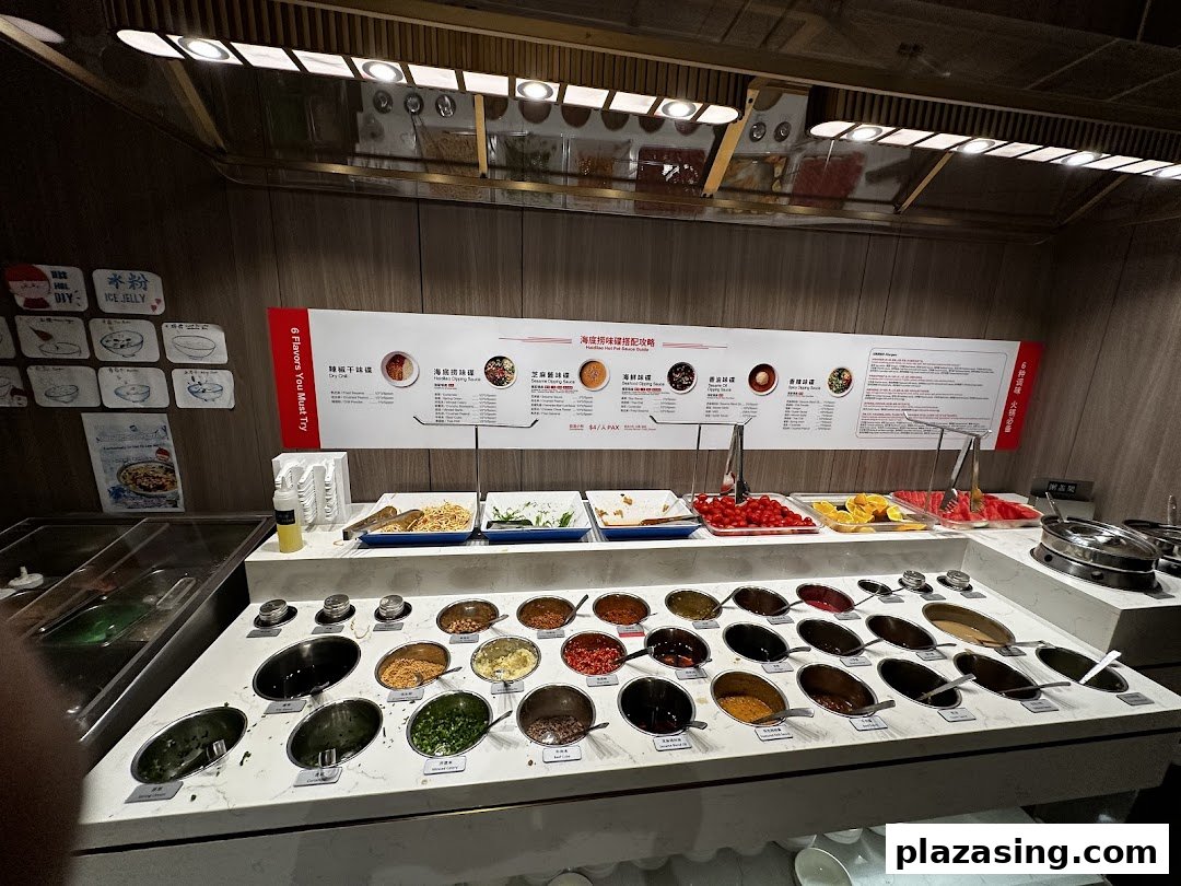 A vibrant self-service sauce and condiment bar at Haidilao Hot Pot, featuring fresh ingredients and custom mixes.