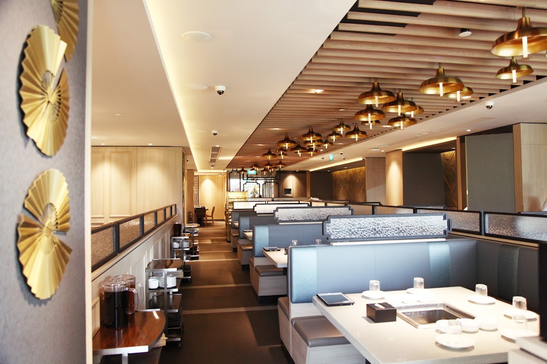Spacious and modern interior dining area of a hot pot restaurant with comfortable booth seating.