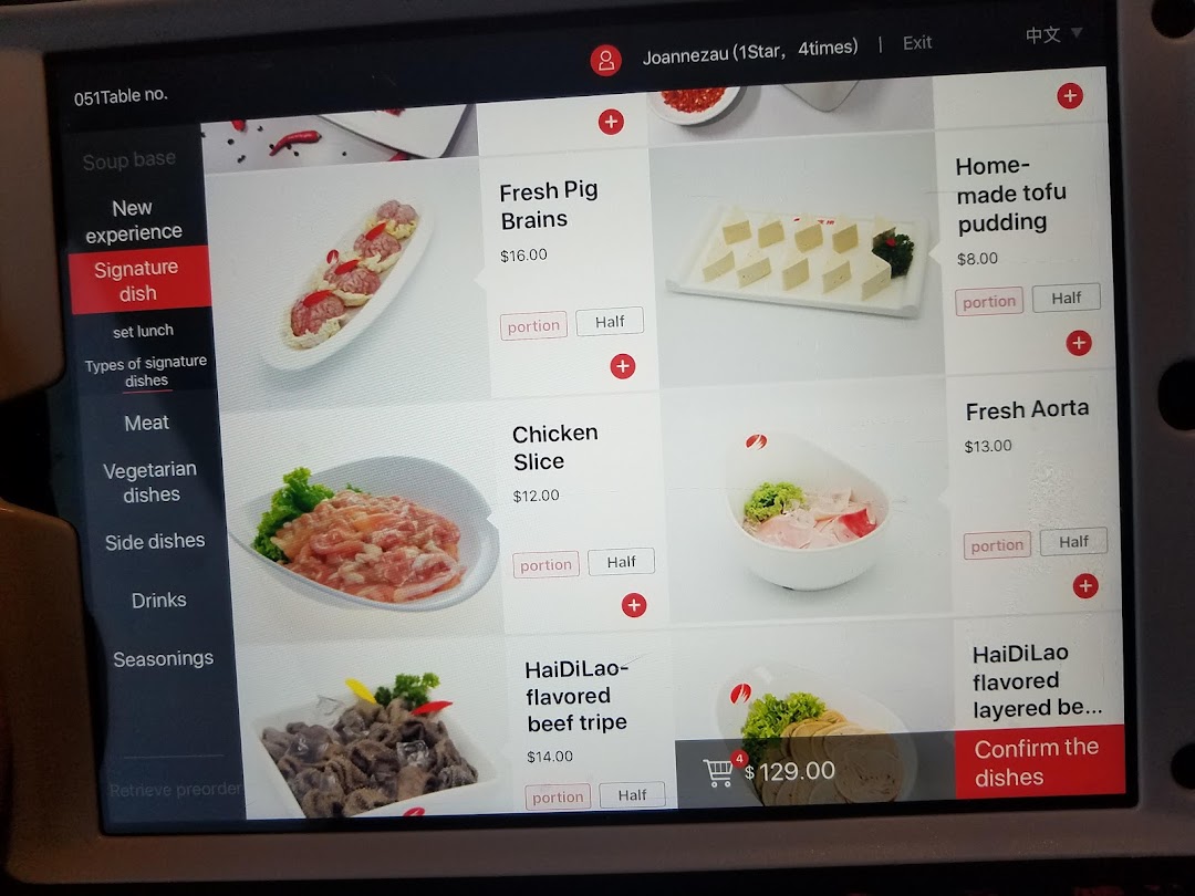 A digital menu screen at Haidilao Hot Pot, displaying various hot pot ingredients and prices.