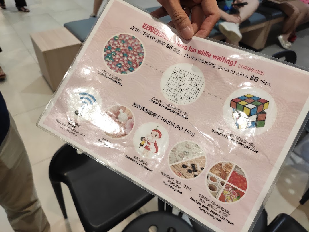 A Haidilao Hot Pot waiting area activity sheet offering games and complimentary services.